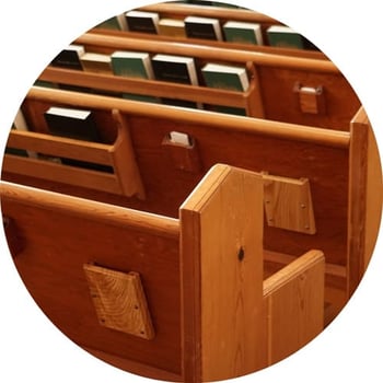 Row of church pews with hymnals.