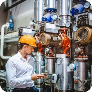 Facility Engineer Inspecting Industrial Pump Systems