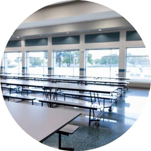 Rows of tables in a school cafeteria.