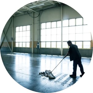 Janitor mopping a gymnasium floor.