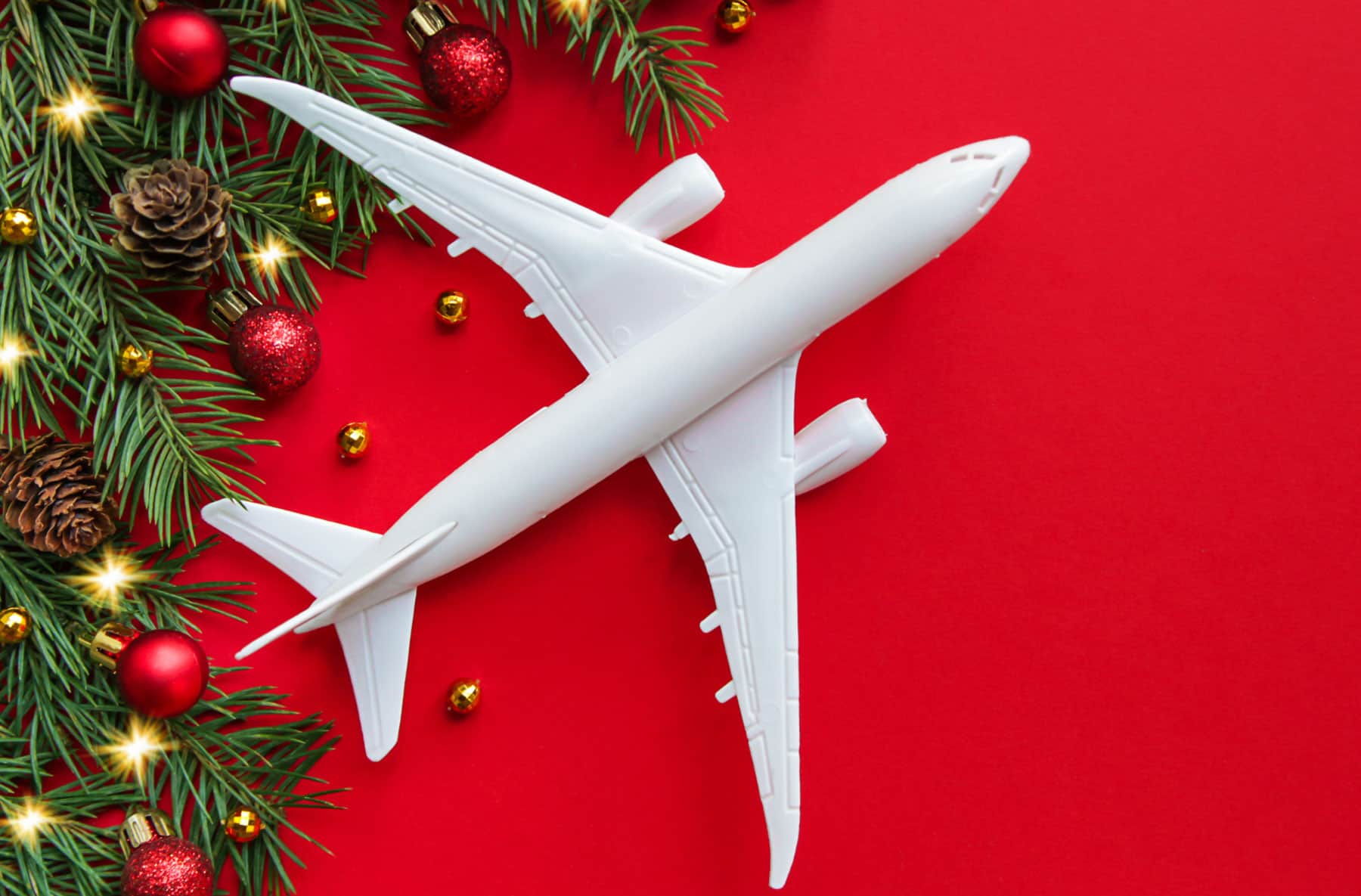 Airplane with red background and Christmas decorations